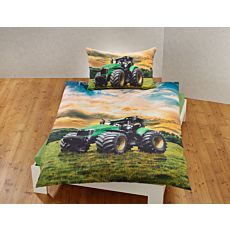 Parure de lit avec un grand tracteur sur un pré vert