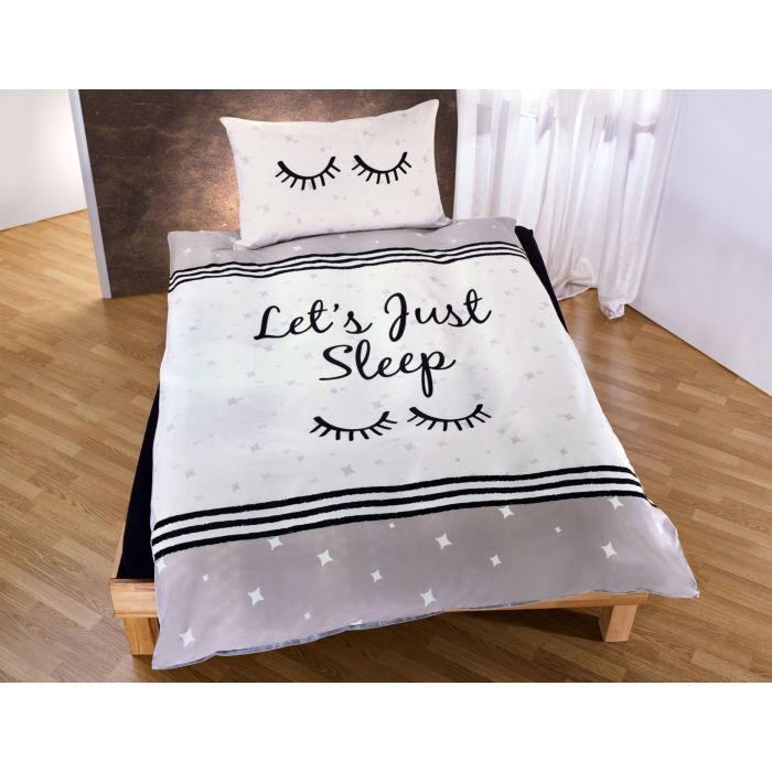 Linge de lit orné de paupières fermées sur fond d'étoiles main product photo